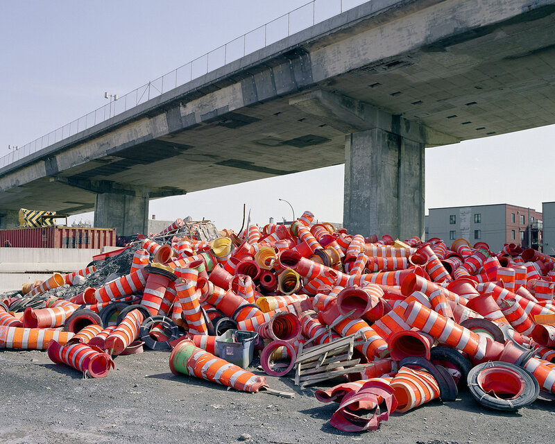 Pile of traffic cones under a bridge