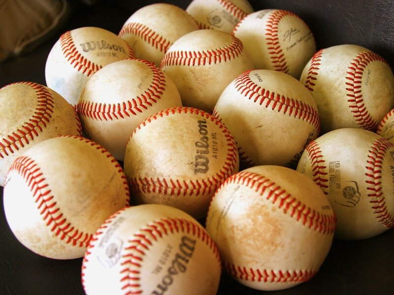 pile of used baseballs