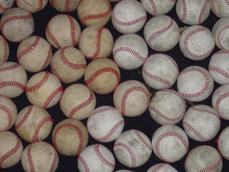 pile of used baseballs