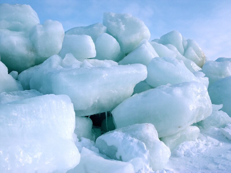 Piled ice blocks on shore