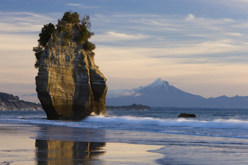 Pillar rock at beach with mountain