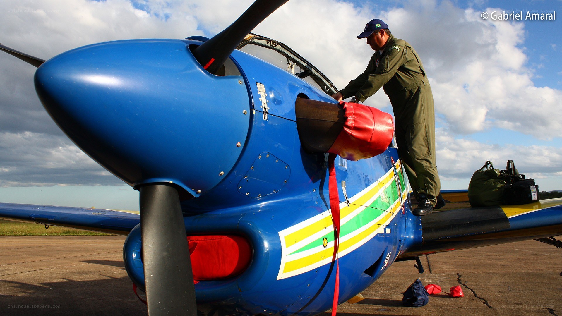 Pilot boarding a blue aircraft