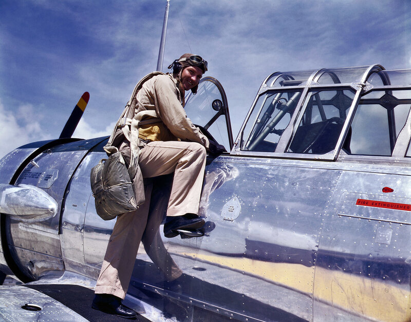 Pilot boarding a vintage aircraft