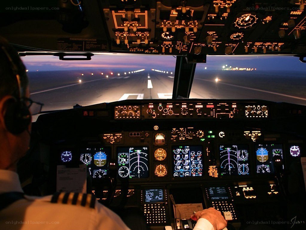 Pilot in cockpit at dusk