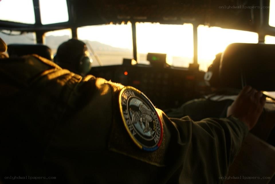 Pilot in cockpit at sunset