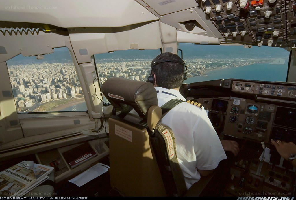 Pilot in cockpit over city