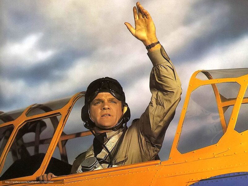 pilot in cockpit waving
