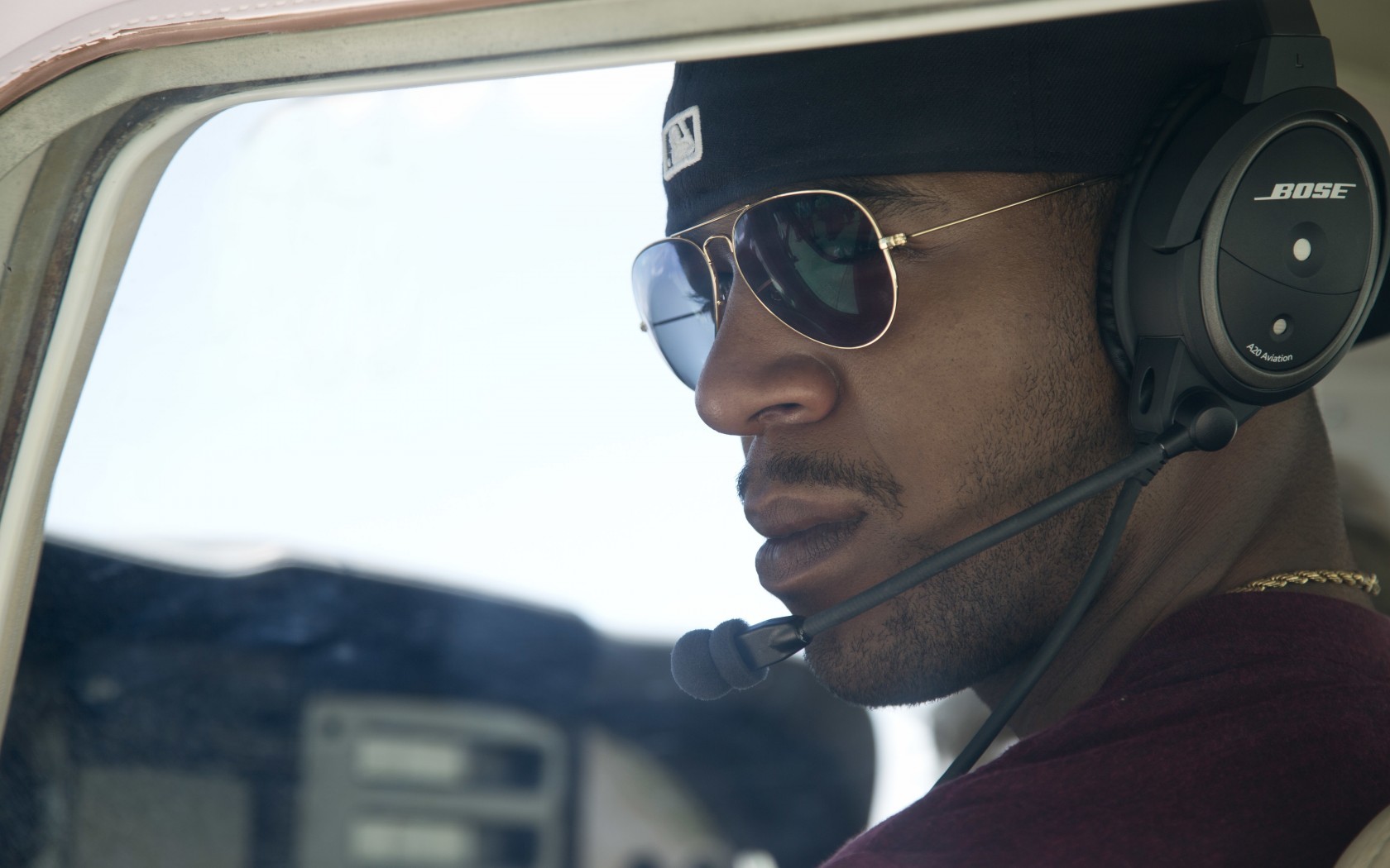 pilot in cockpit wearing headset