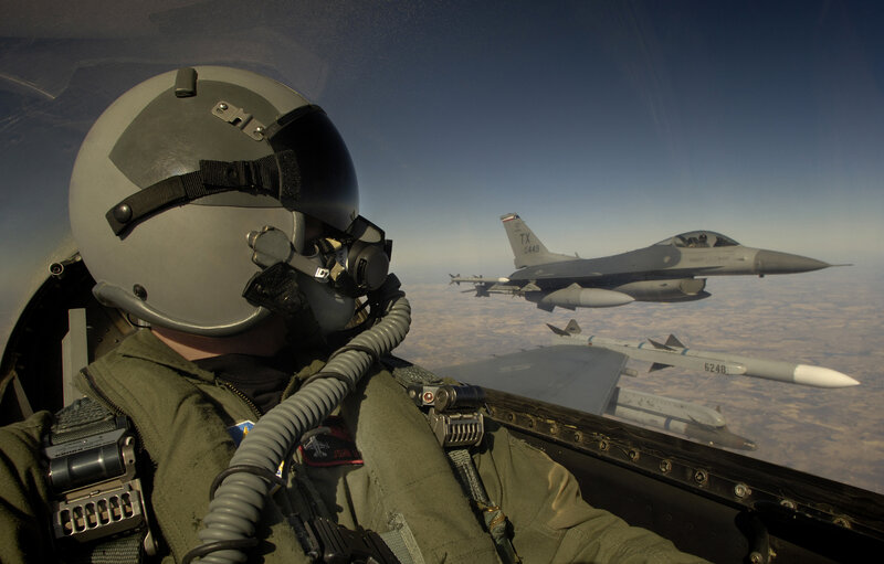 Pilot in cockpit with fighter jet