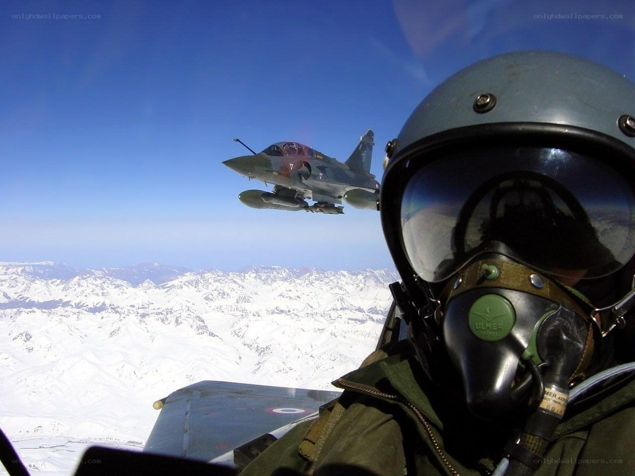 Pilot in cockpit with fighter jet