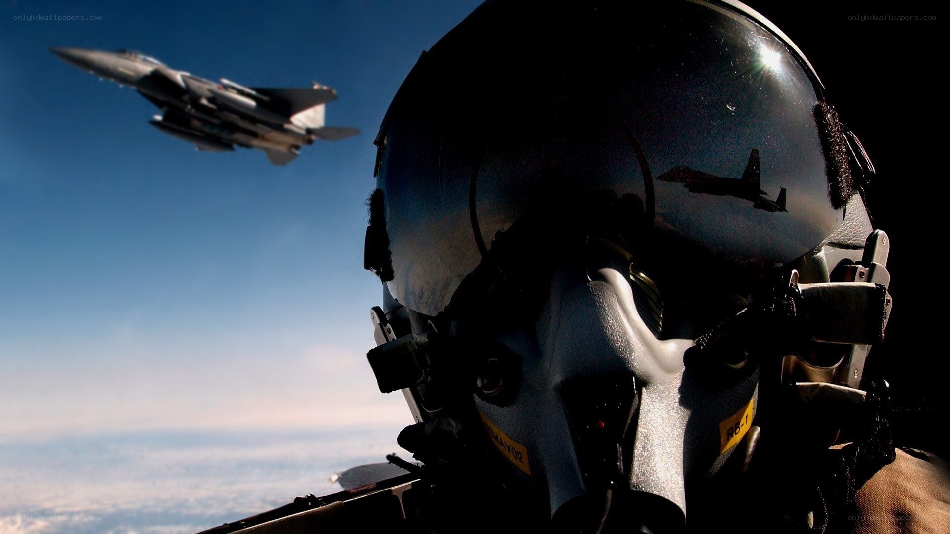 Pilot in cockpit with fighter jet