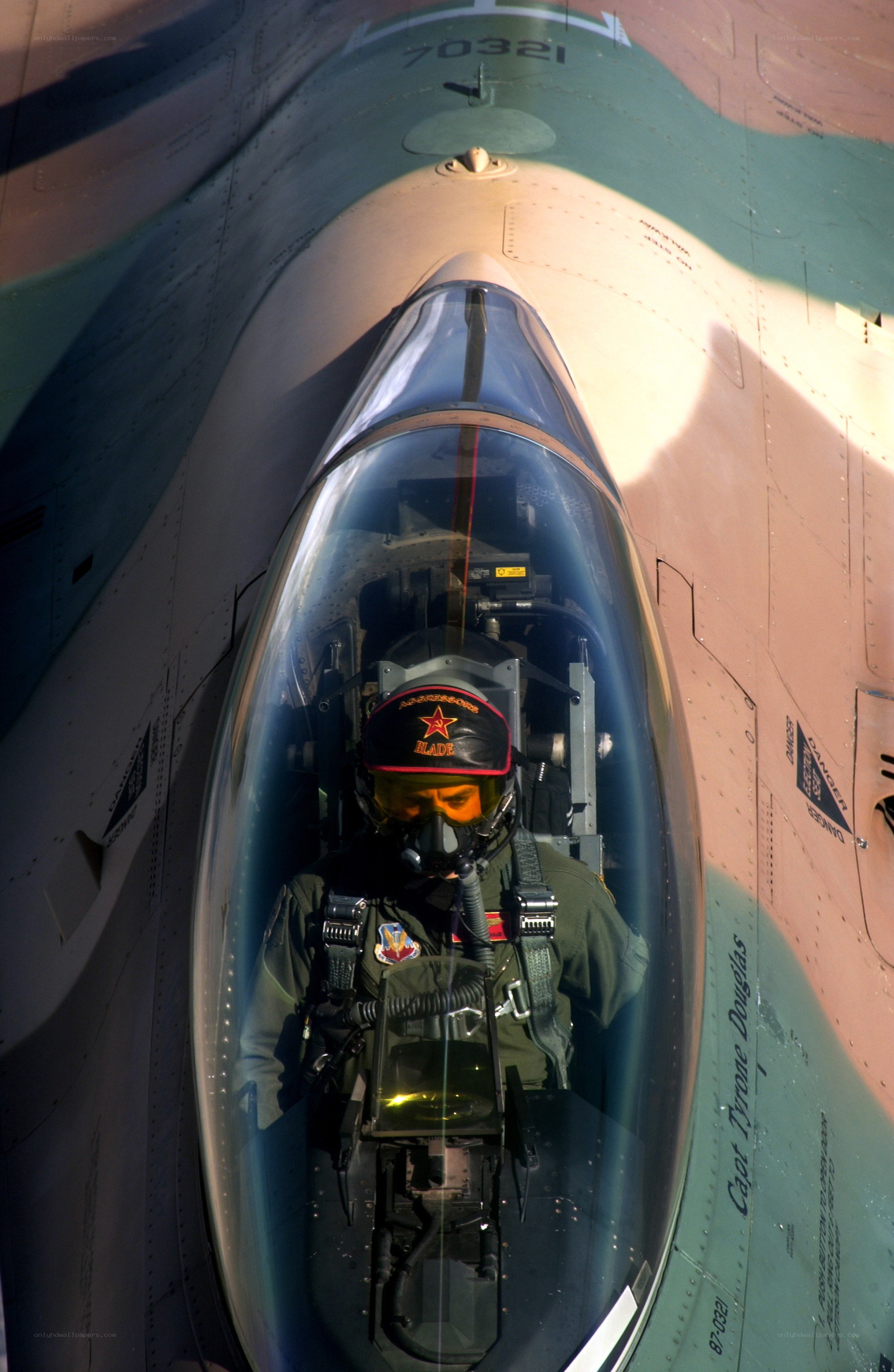 Pilot in fighter jet cockpit