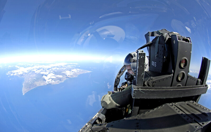 Pilot in fighter jet cockpit