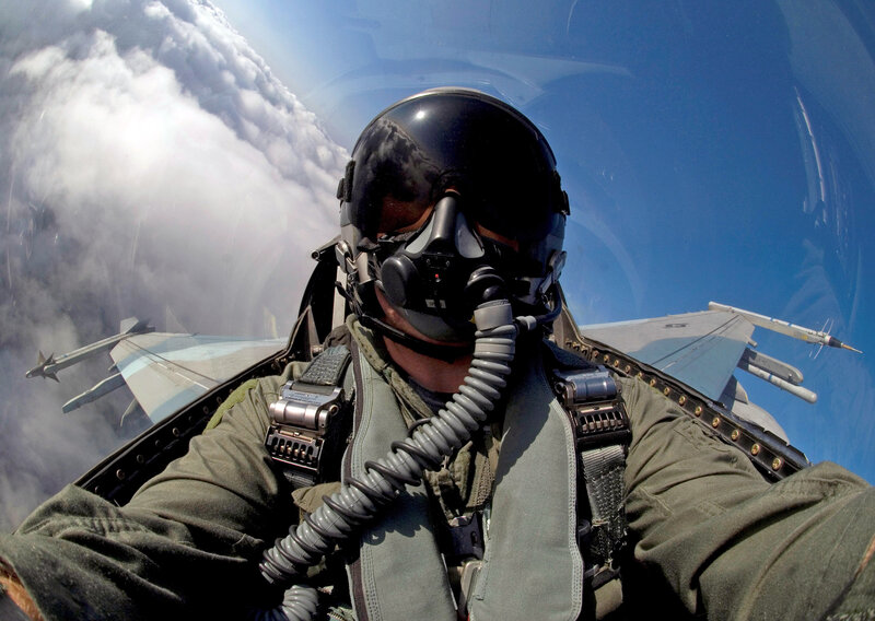 Pilot in fighter jet cockpit