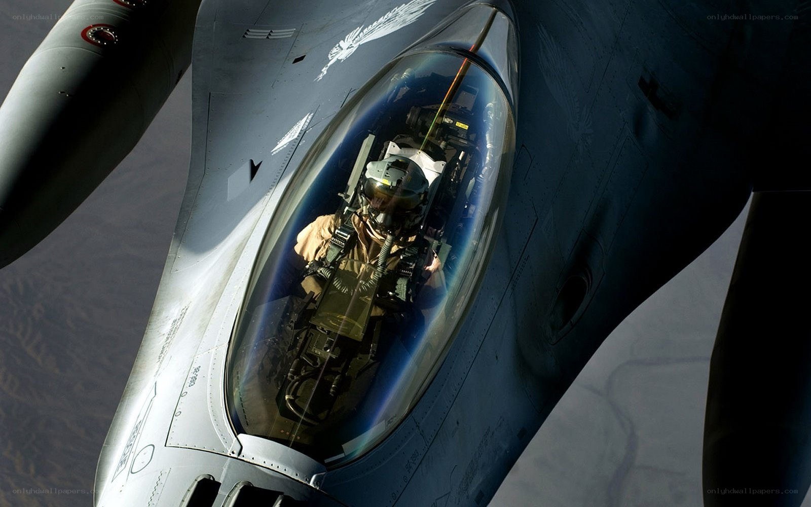 Pilot in fighter jet cockpit