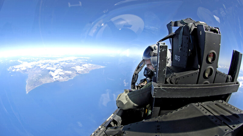 Pilot in fighter jet cockpit