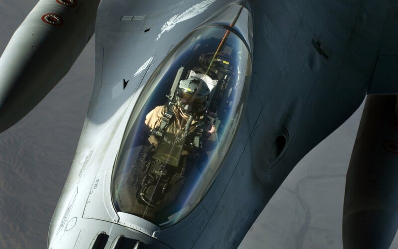 pilot in fighter jet cockpit