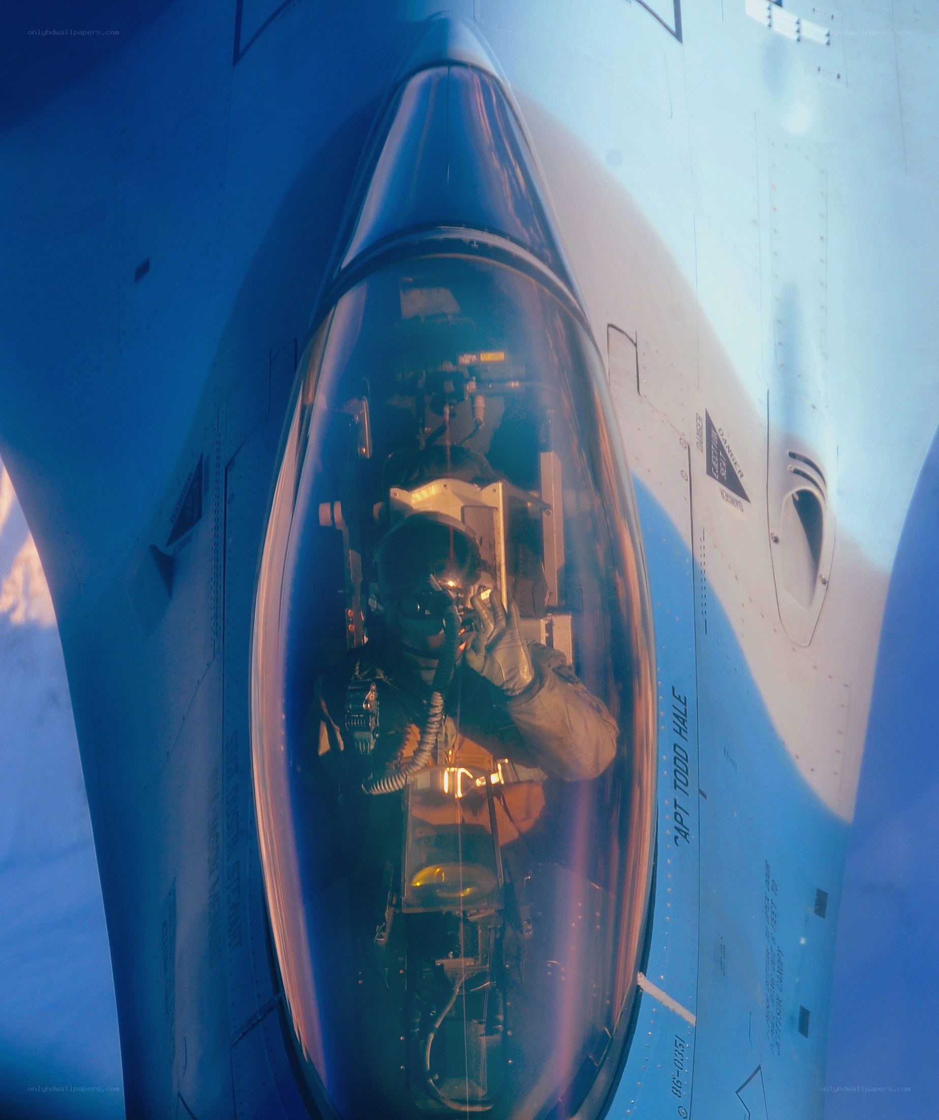 pilot in fighter jet cockpit