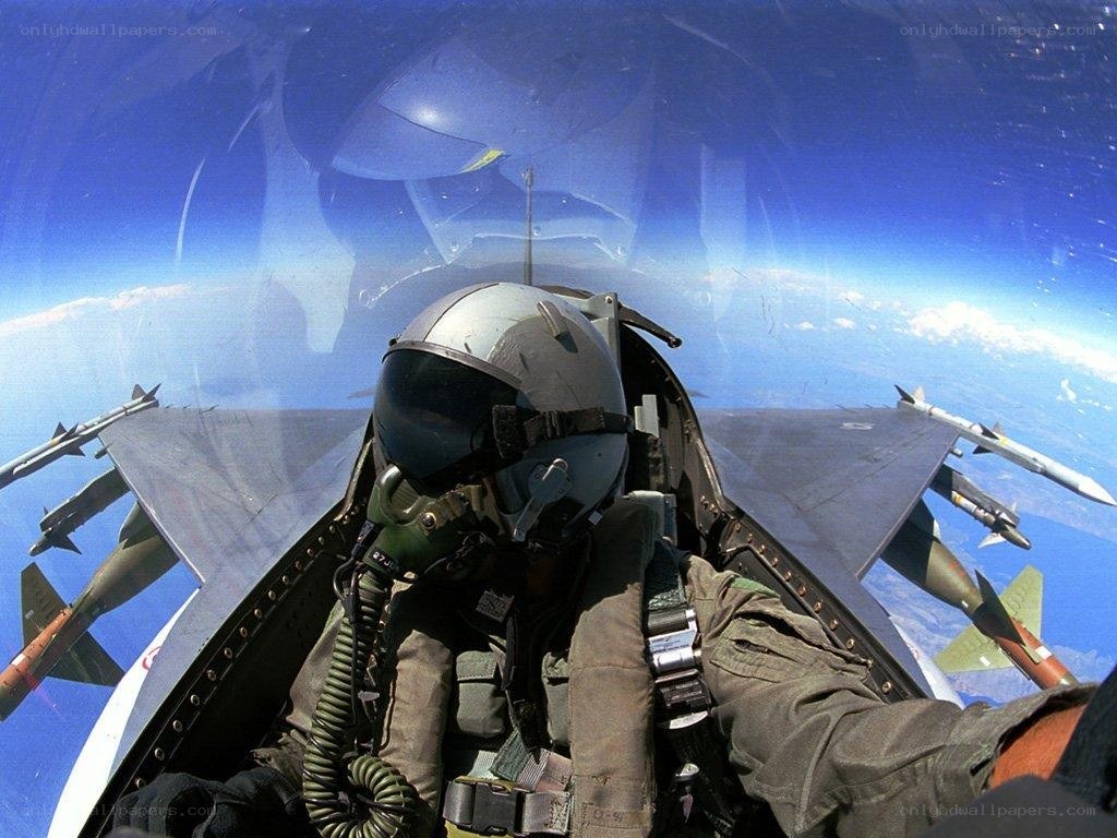 Pilot in fighter jet cockpit