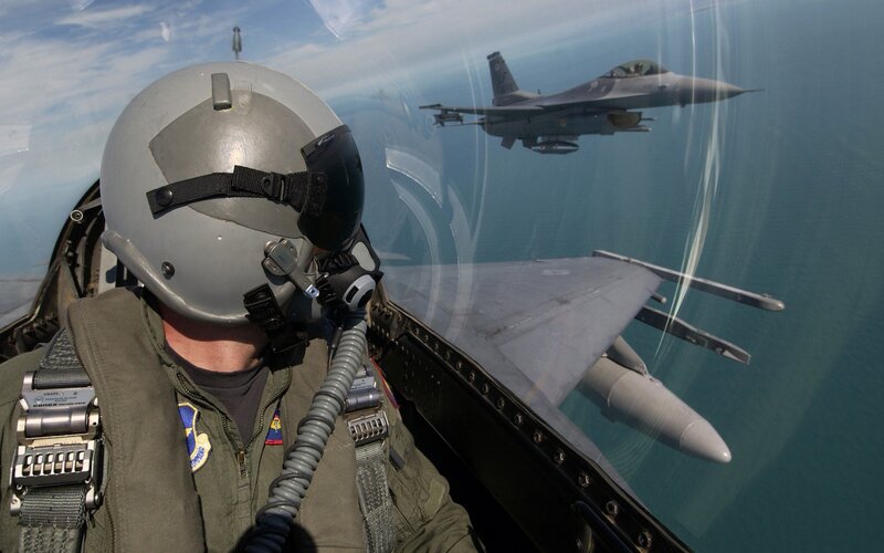 Pilot in fighter jet cockpit