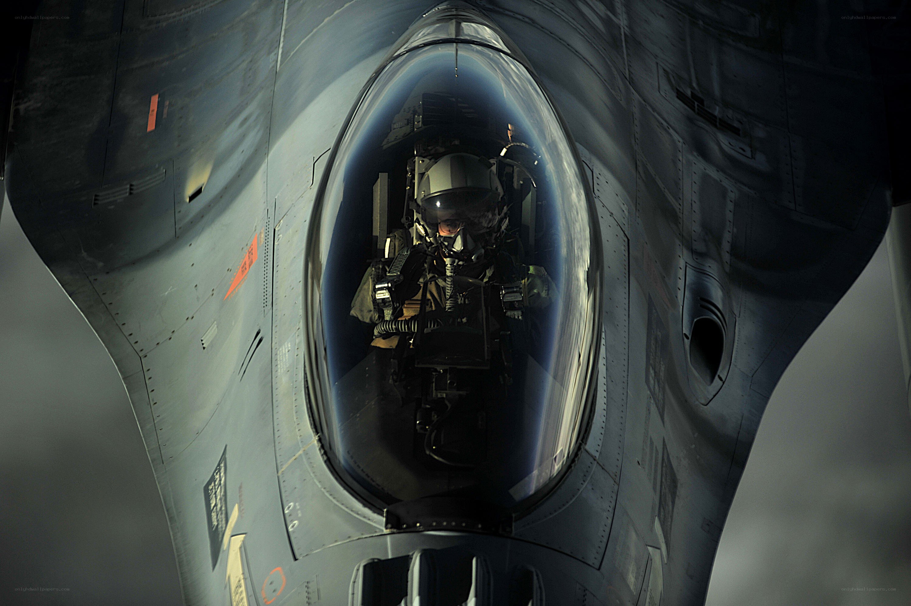Pilot in fighter jet cockpit
