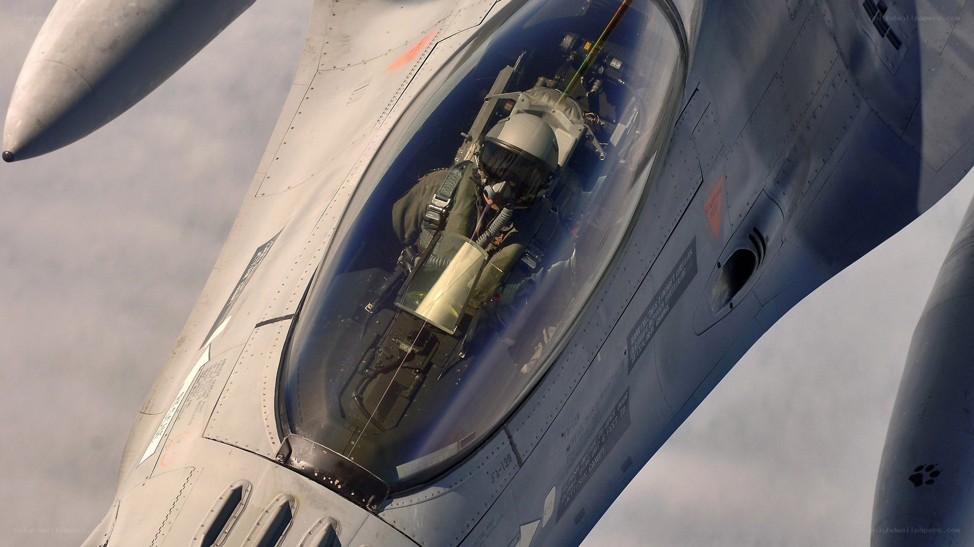 pilot in fighter jet cockpit