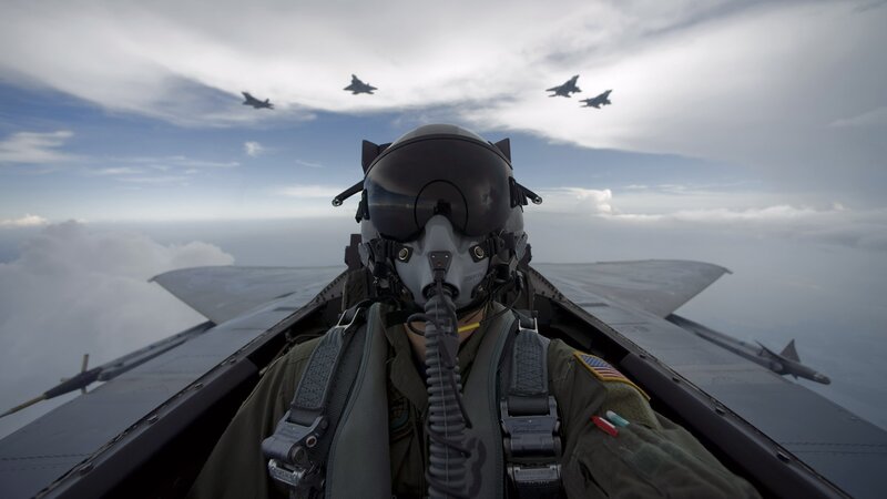 Pilot in fighter jet cockpit