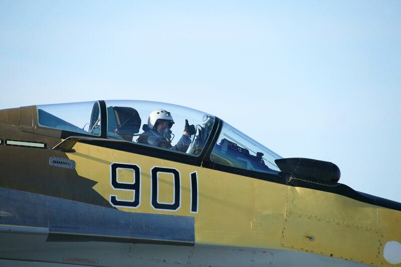 Pilot in fighter jet cockpit