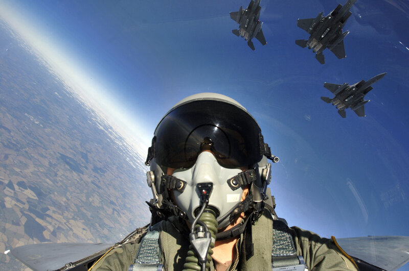 Pilot in fighter jet cockpit