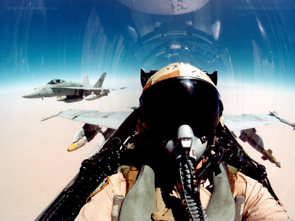 Pilot in fighter jet cockpit
