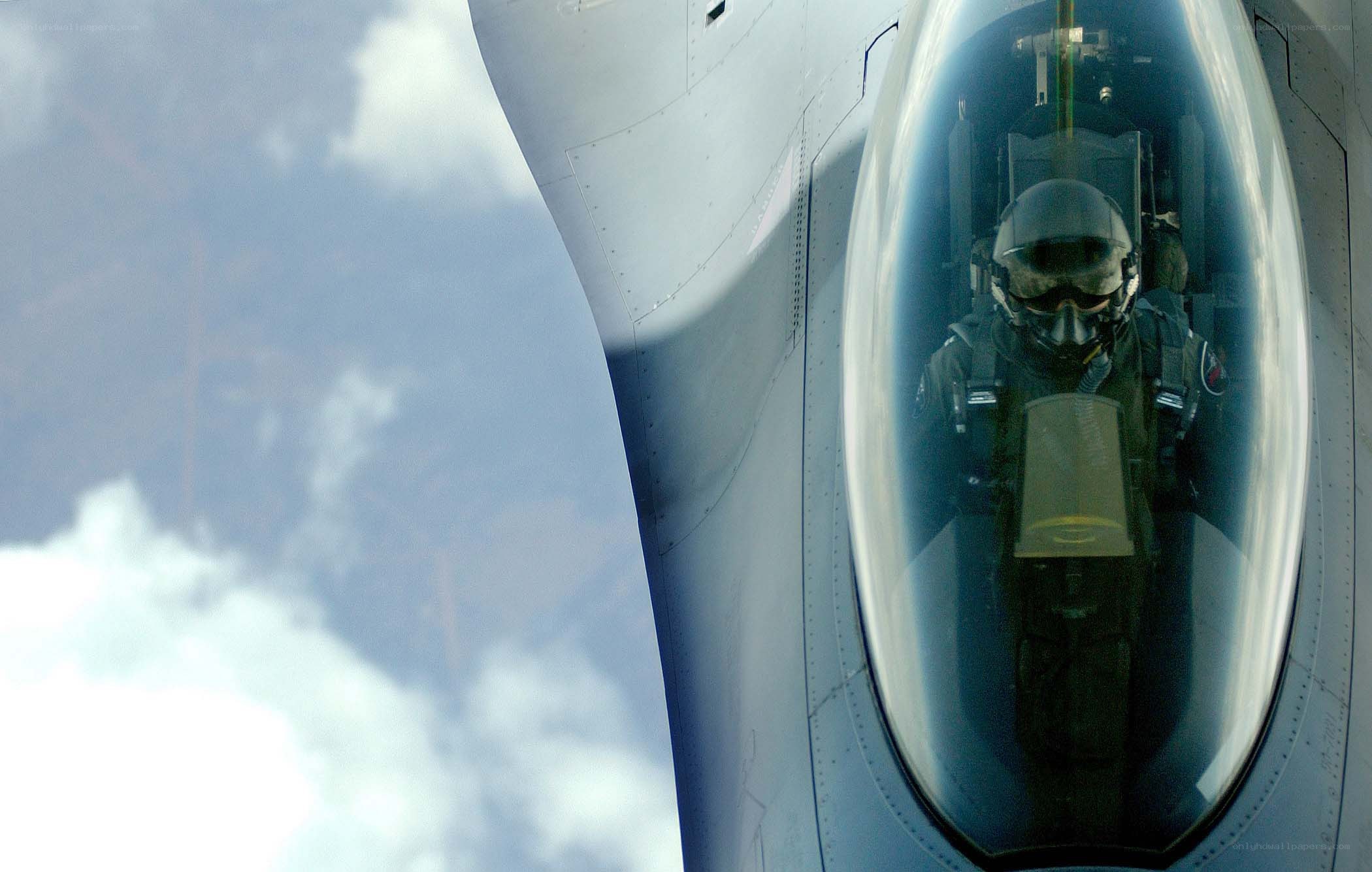 pilot in fighter jet cockpit