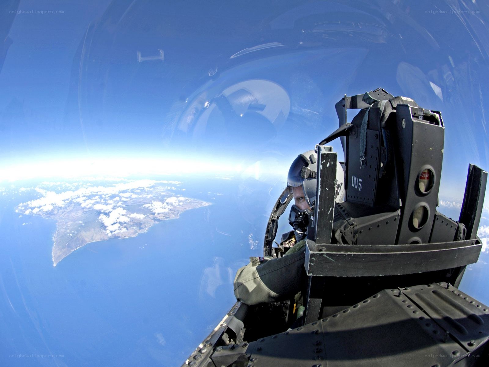 Pilot in fighter jet cockpit
