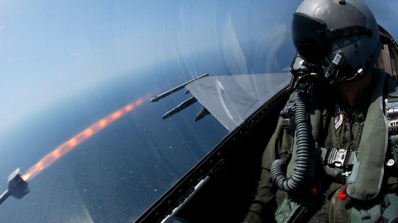 Pilot in fighter jet firing missile