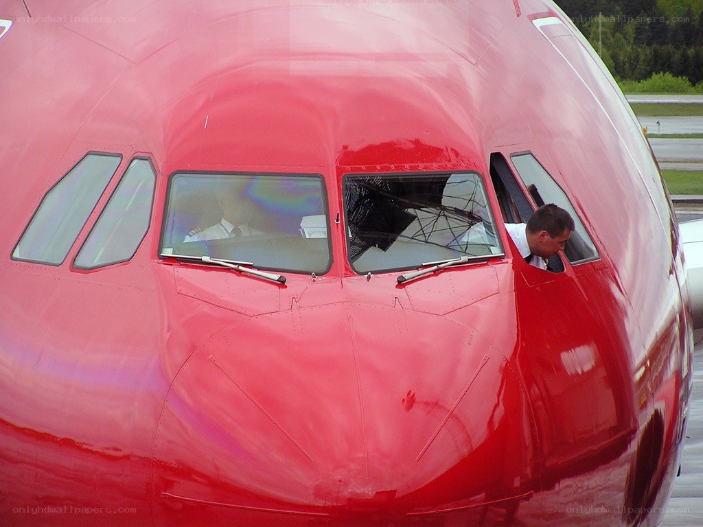 Pilot in red airplane cockpit