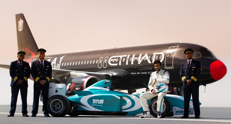 Pilots and race car driver with Etihad plane