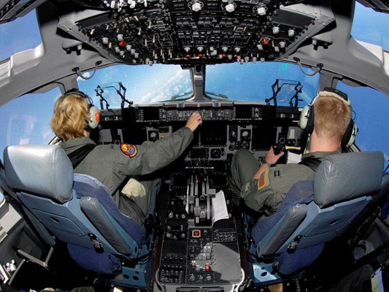 Pilots in Aircraft Cockpit — Blue