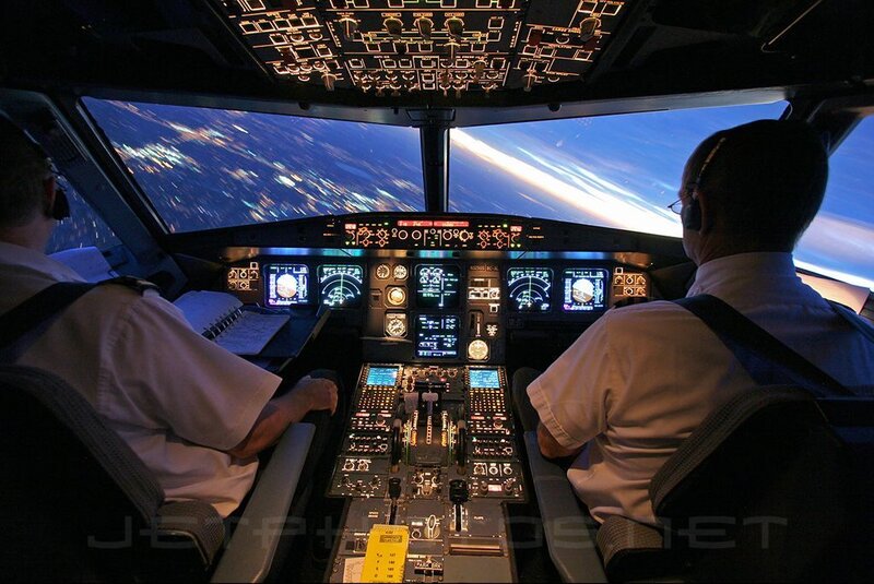 Pilots in cockpit at night