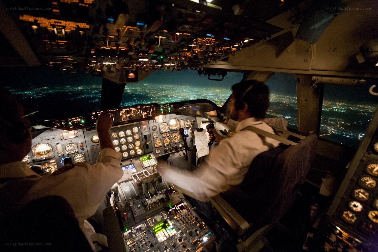 Pilots in cockpit at night