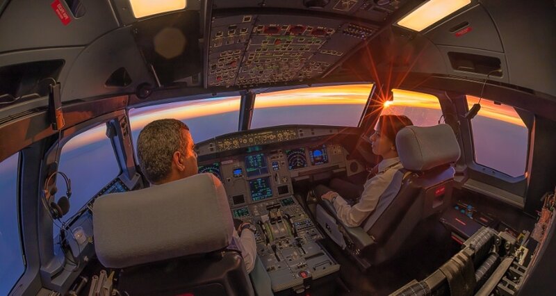Pilots in Cockpit — Orange