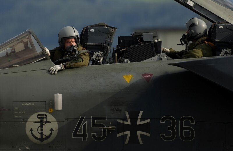 Pilots in fighter jet cockpit