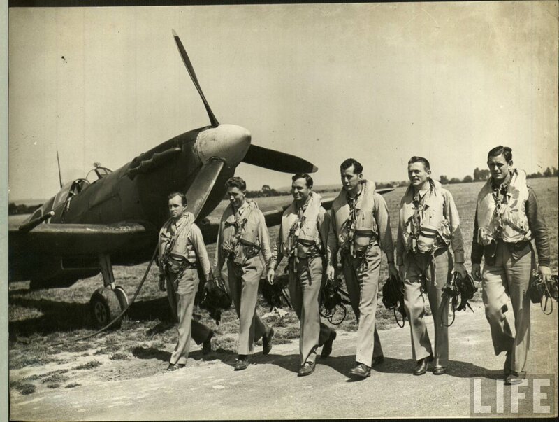 Pilots walking near a Spitfire