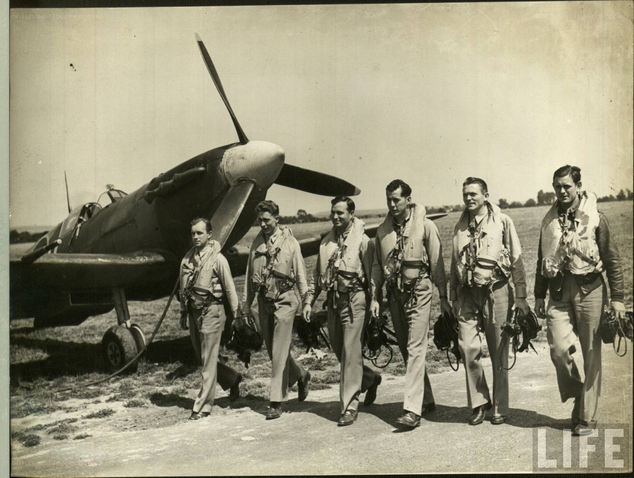 Pilots walking near a Spitfire