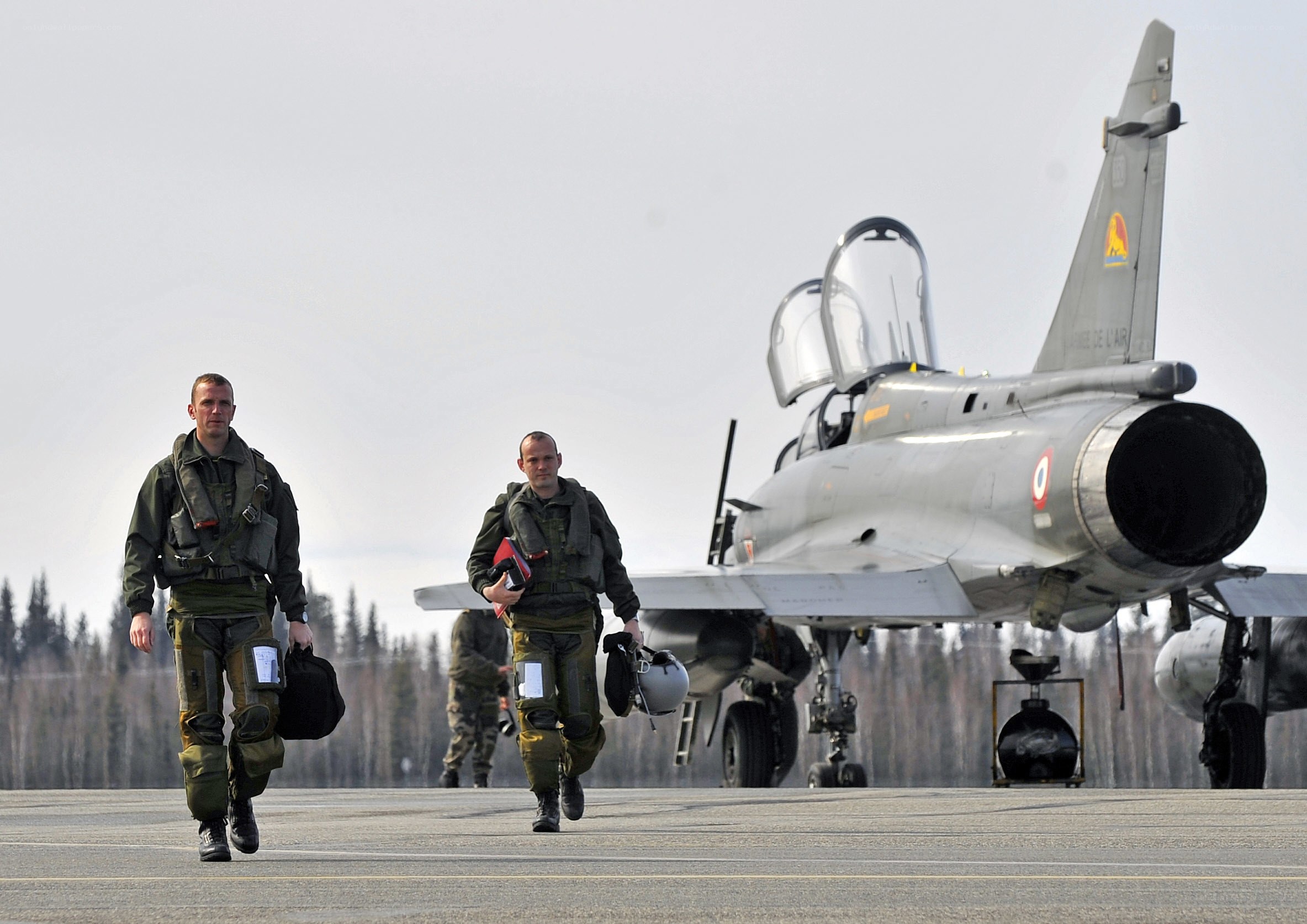 Pilots walking near fighter jet