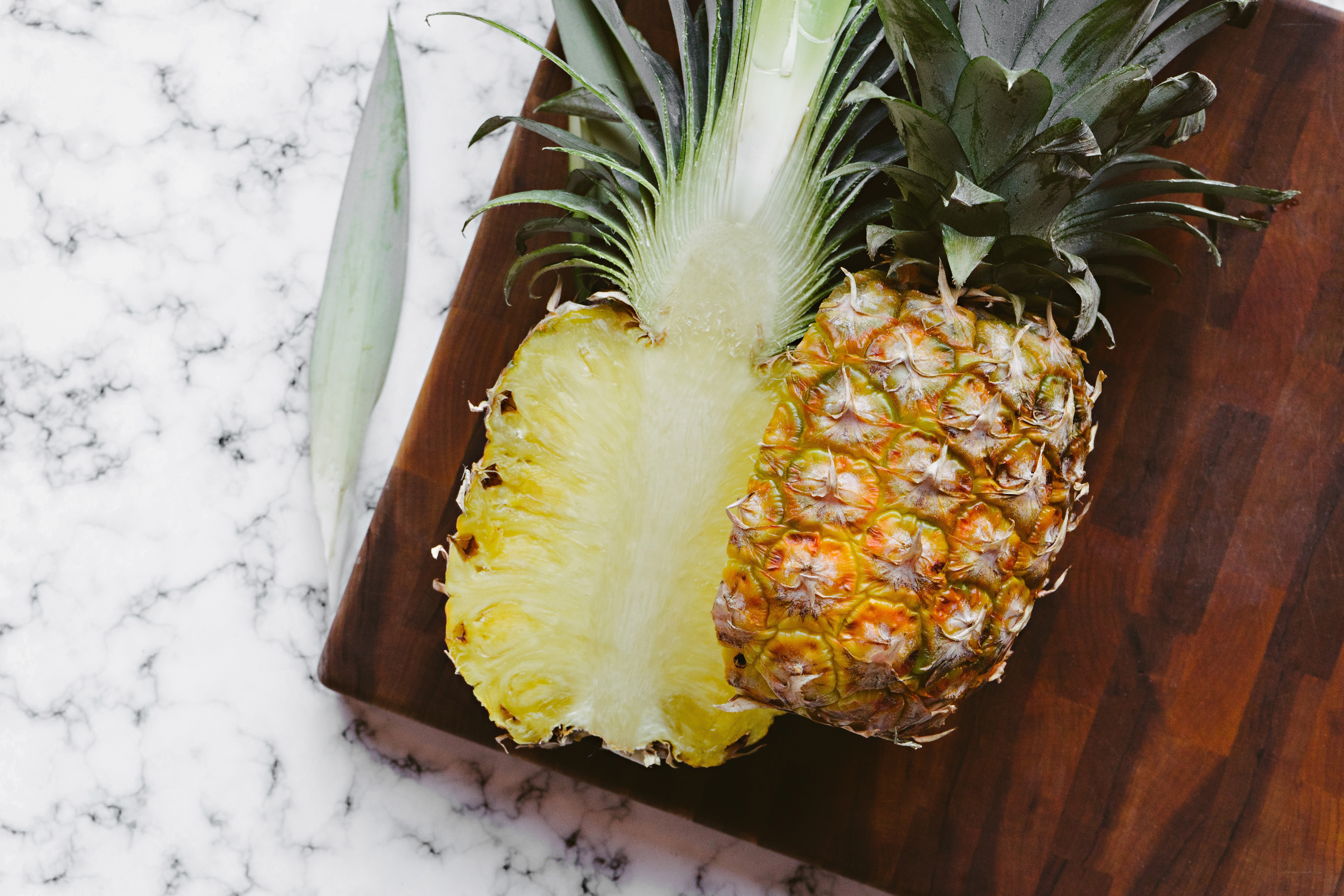 Pineapple on wooden board