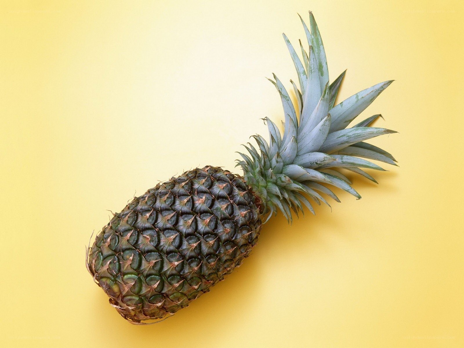 Pineapple on yellow background