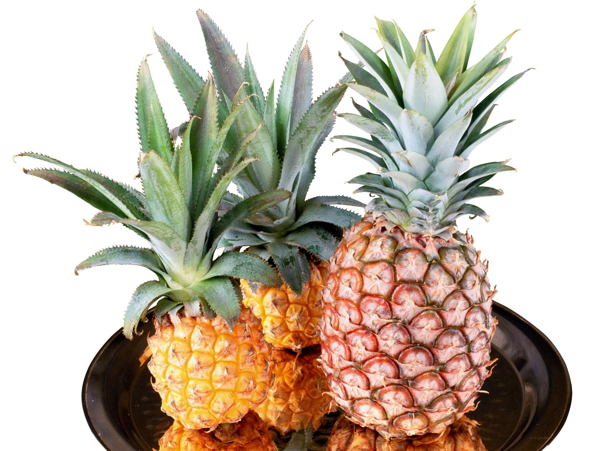 Pineapples on a black plate