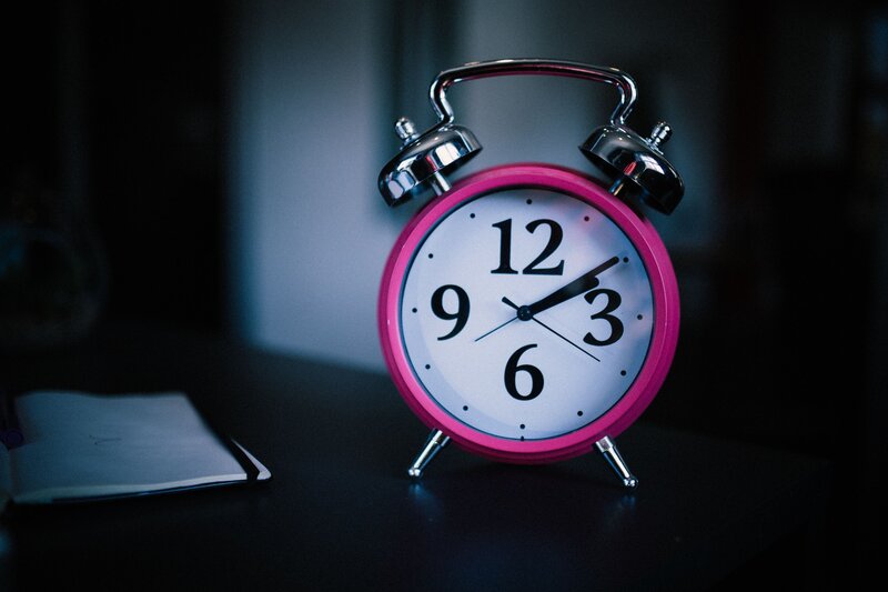 Pink alarm clock on a table