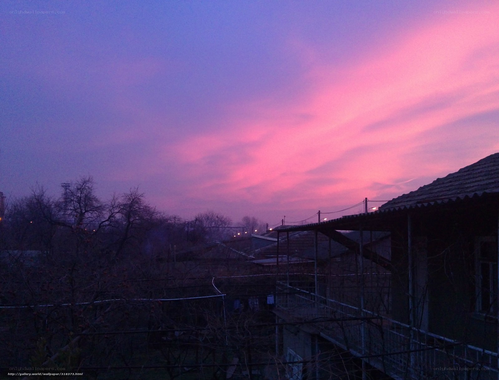 Pink and purple sunset over rooftops