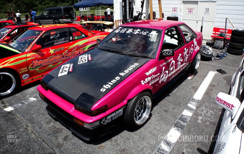 Pink and red race cars at event