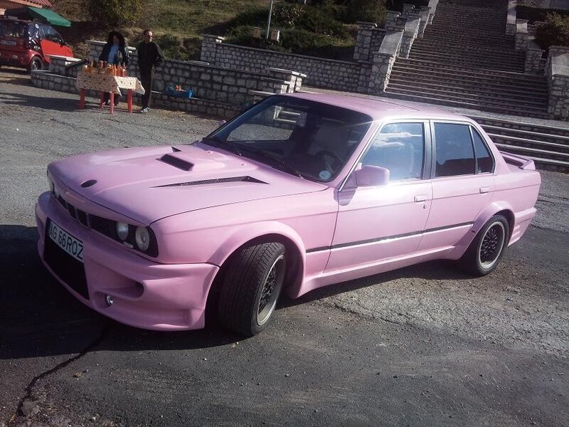 Pink BMW sedan at outdoor gathering